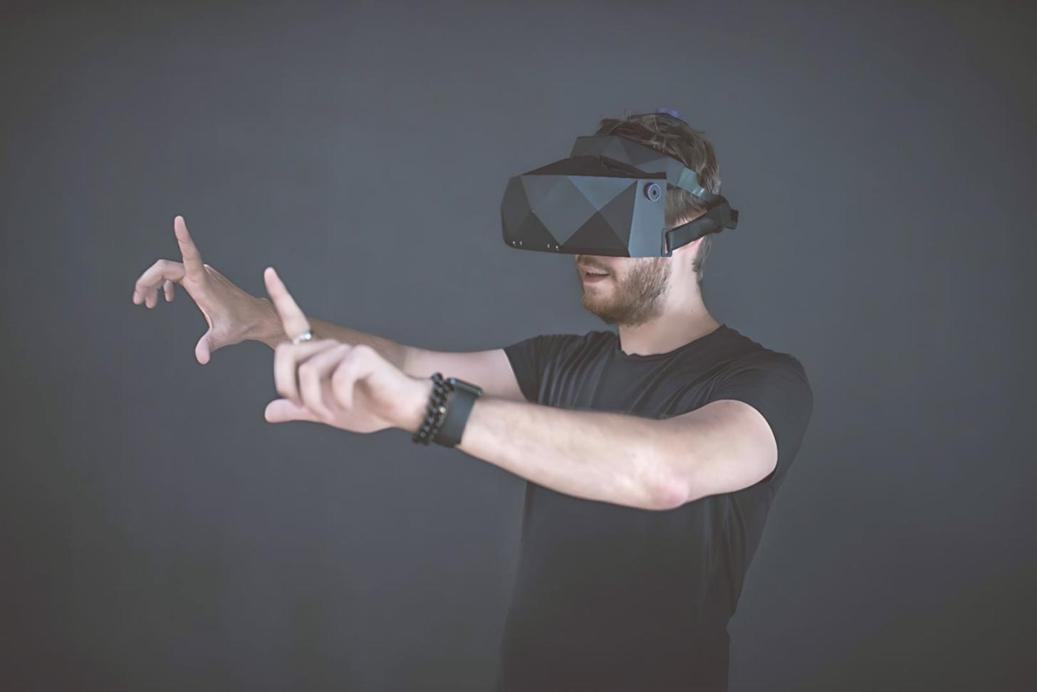 AR development workspace with multiple screens showing Unity interface and VR headset testing setup